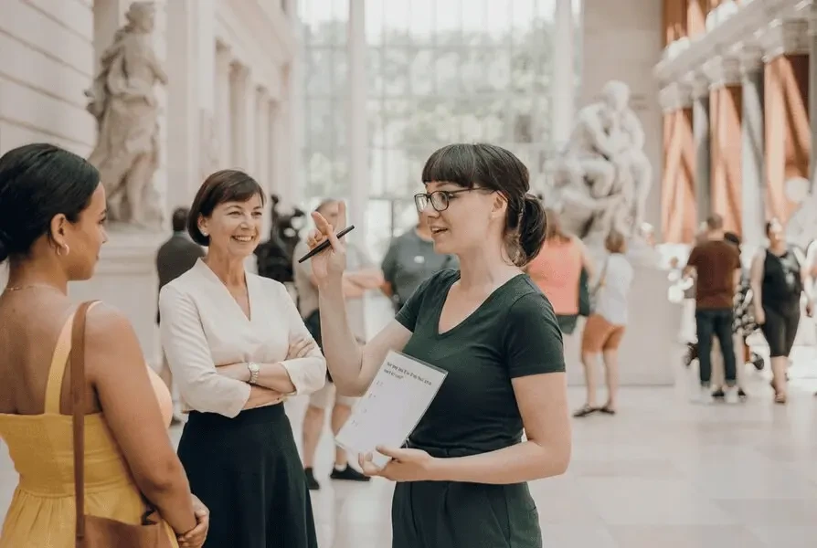 Tour guide shows sights to participants on a city tour and uses a tablet for ticket validation